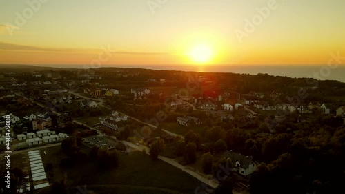 Sunset over rural Baltic coast town Jastrzebia Gora in Poland, orange glow photo