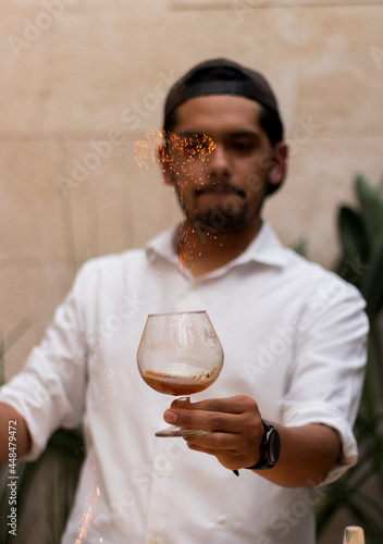 A man preparing a flaming drink