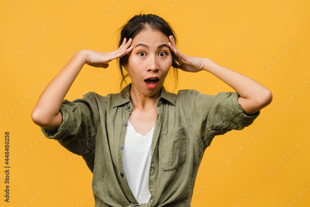 Young Asia lady feel happiness with positive expression, joyful surprise funky, dressed in casual cloth and looking at camera isolated on yellow background. Happy adorable glad woman rejoices success. Young Asia lady feel happiness with positive expression, joyful surprise funky, dressed in casual cloth and looking at camera isolated on yellow background. Happy adorable glad woman rejoices success.