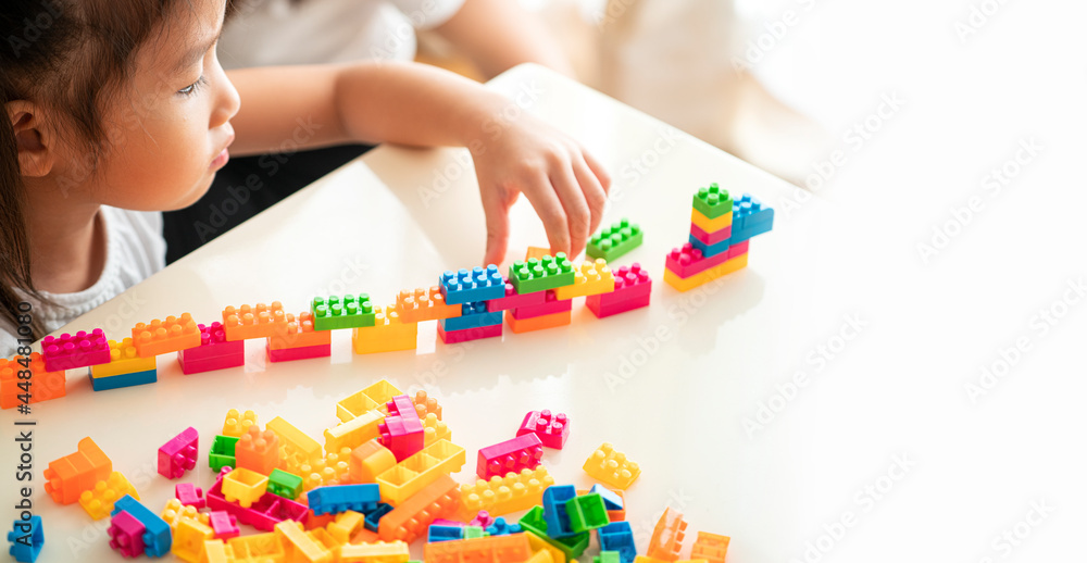Fototapeta premium Banner photo of Asian Girl playing block toy with her mother in living room, Asian Family concept