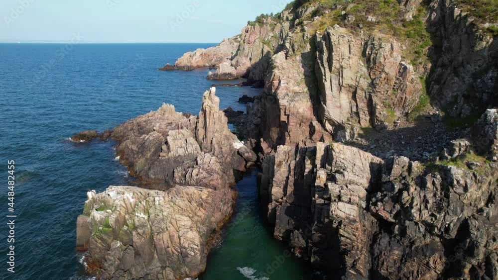 Cinematic slow flying aerial view of coast with cliffs, waves and ocean, Kullaberg Sweden Cinematic slow flying aerial view of coast with cliffs, waves and ocean, Kullaberg Sweden