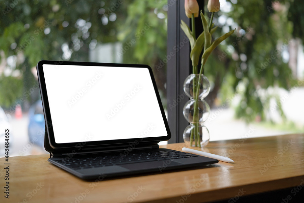 Close up computer table with white screen on wooden table. Close up computer table with white screen on wooden table.