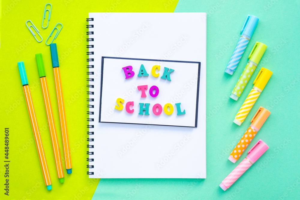 Back to school inscription made of multicolored letters. A stack of ...