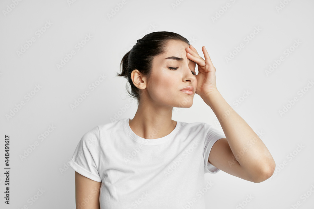 woman in white t-shirt emotion displeasure headache health problems woman in white t-shirt emotion displeasure headache health problems