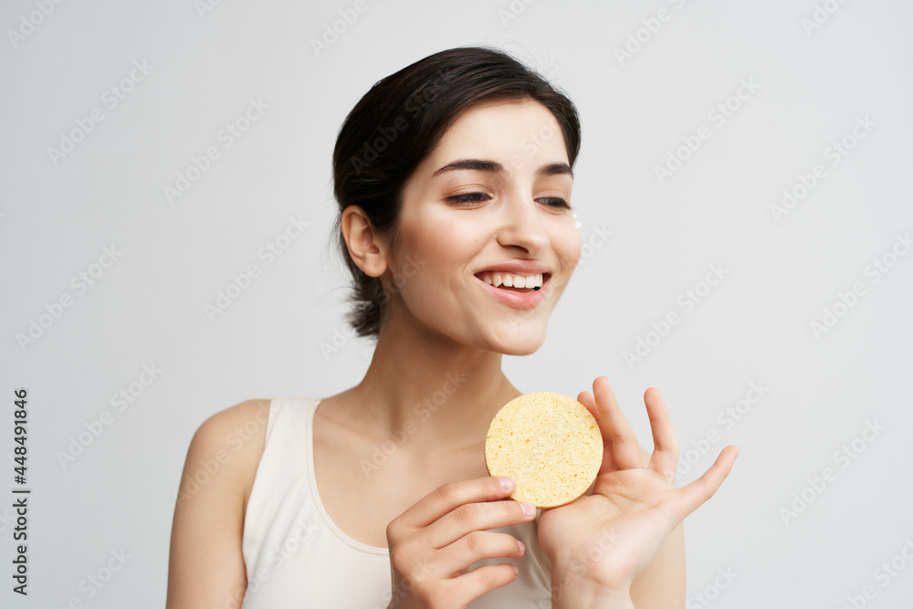 cute brunette in white tank top sponge face clean skin cute brunette in white tank top sponge face clean skin