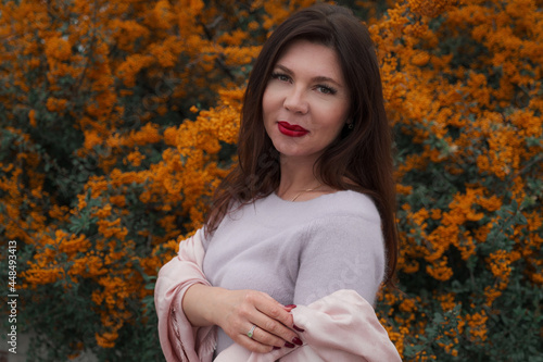 Portrait of a gorgeous middle-aged woman in an autumn park