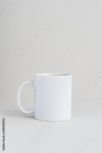 Single white mug on light gray background, mockup