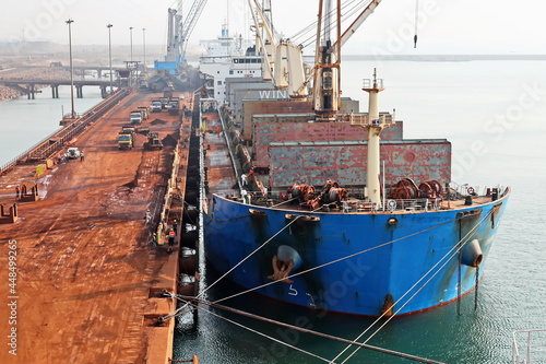 A large bulk carriers, tugboats at the port under cargo operations and underway.  Gopalpur, India, November, 2020. photo