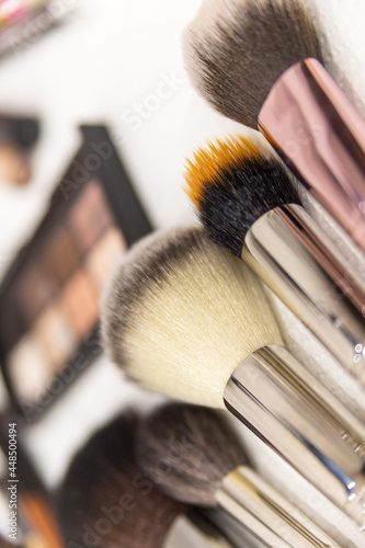 A set of brushes and professional cosmetics on the makeup artist's desk. Everything for applying makeup. Suitable for your beauty blog. Make up the most necessary things. Flatly. Soft focus.