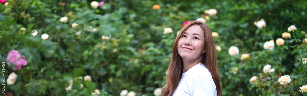 Portrait image of a beautiful young asian woman in roses flower garden Portrait image of a beautiful young asian woman in roses flower garden