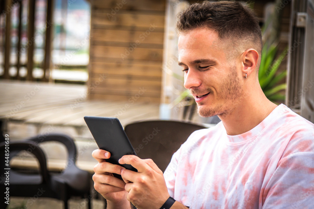 man with digital tablet or ebook in outdoor cafe man with digital tablet or ebook in outdoor cafe