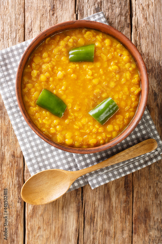 Kik Alicha Ethiopian Yellow Split Pea Stew closeup in the bowl on the table. Vertical top view from above photo