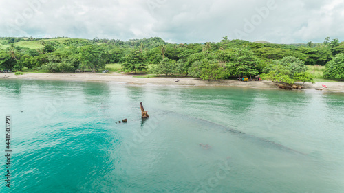 A closer aerial look at a World War 2 shipwreck of the Kinugawa Maru that lies next to a beach on Guadalcanal island.