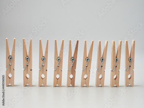 Set of wooden clothes pins on white background