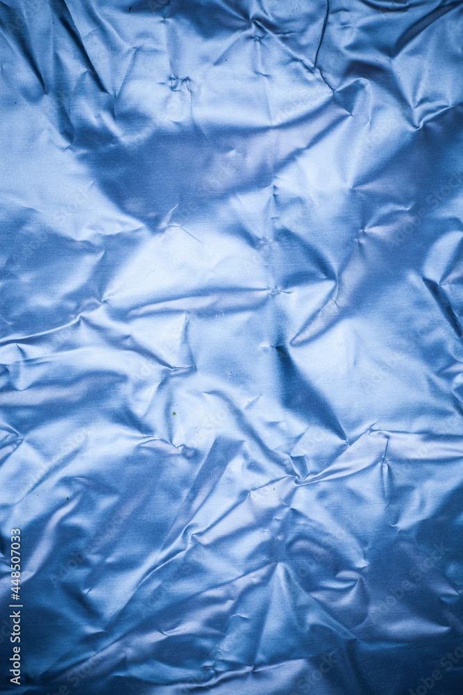 Obraz premium Crumpled blue aluminum foil background.