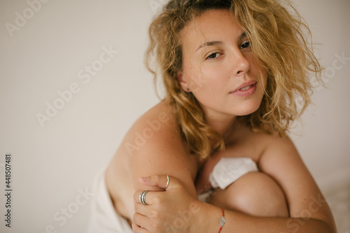 Young beautiful woman with no make up and perfect skin on white background.