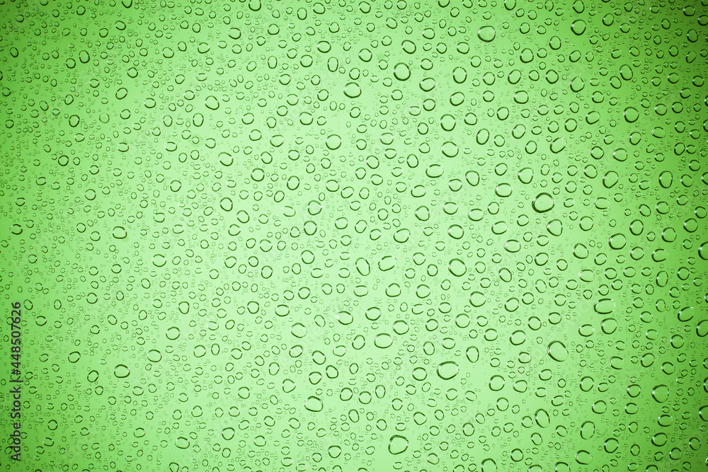 Water bubble on green glass.