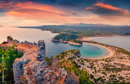 Azure summer view of Voidokilia Beach from Old Navarino Castle. Aerial sunset on Ionian sea. Wonderful evening scene of Peloponnese peninsula, Greece, Europe. Beauty of nature concept background.