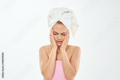 woman with towel on head dermatology skin care close-up