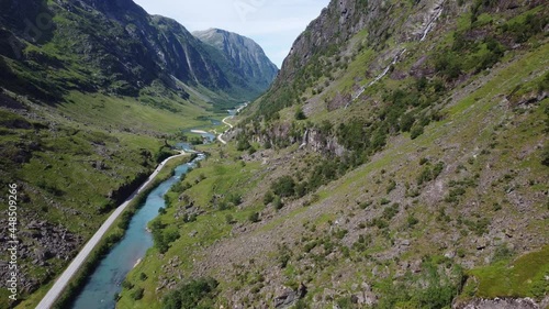 Scenic narrow and deep valley with road E39 passing through - Descending aerial with panoramic view over valley with road and river - Stardalen Valley Norway photo