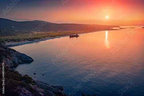 Dramatic sunrise on Valtaki beach with Dimitrios Shipwreck. Breathtaking morning scene of Peloponnese peninsula  Greece  Europe. Spectacular summer seascape of Mediterranean sea.