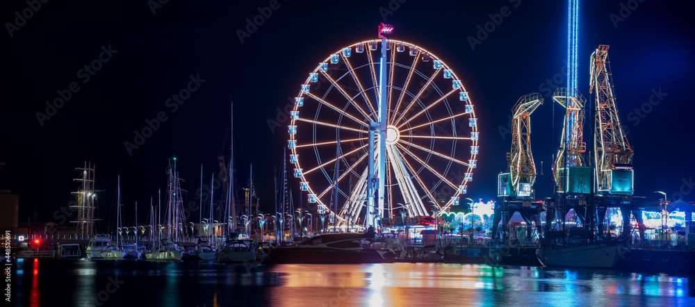 Szczecin, Poland, July 2021: Night amusement park, beautiful illuminations photographed in motion