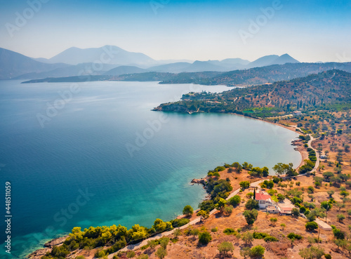 View from flying drone of Doroufi Kranidiou village. Gorgeous summer scene of Peloponnese peninsula, Greece, Europe. Picturesque seascape of Myrtoan Sea. Traveling concept background..