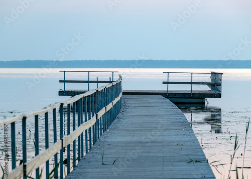 morning landscape with a wooden platform in the water  light before sunrise  silvery water