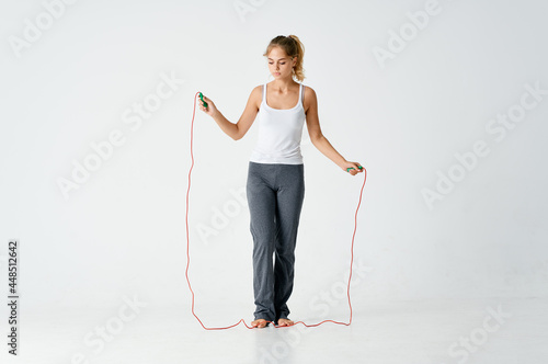 woman with a slim figure works out with a skipping rope exercise gym © SHOTPRIME STUDIO