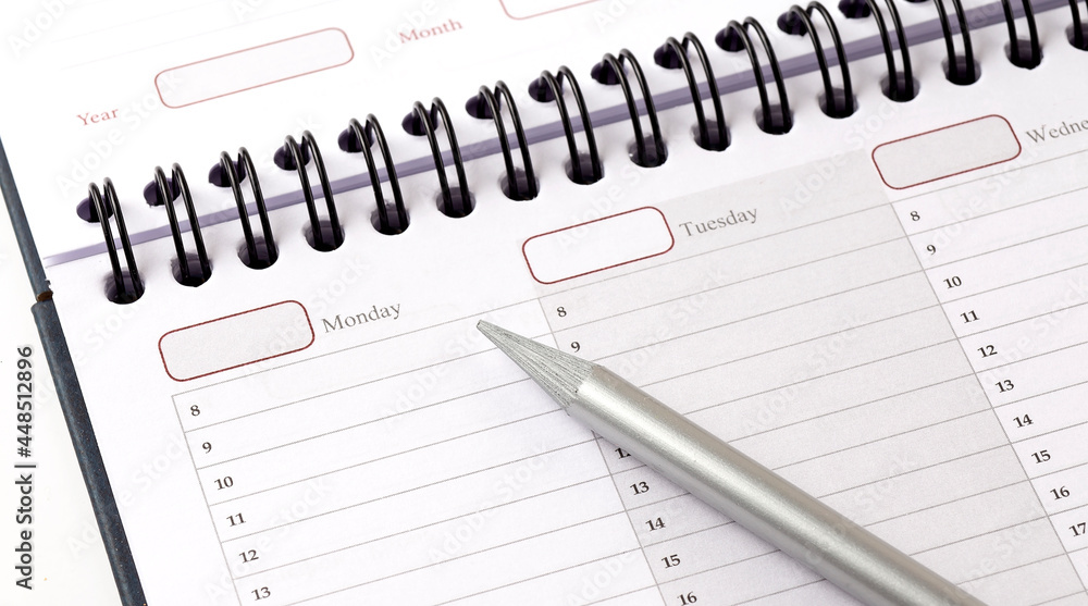 close up top view on white calendar with pencil close up top view on white calendar with pencil