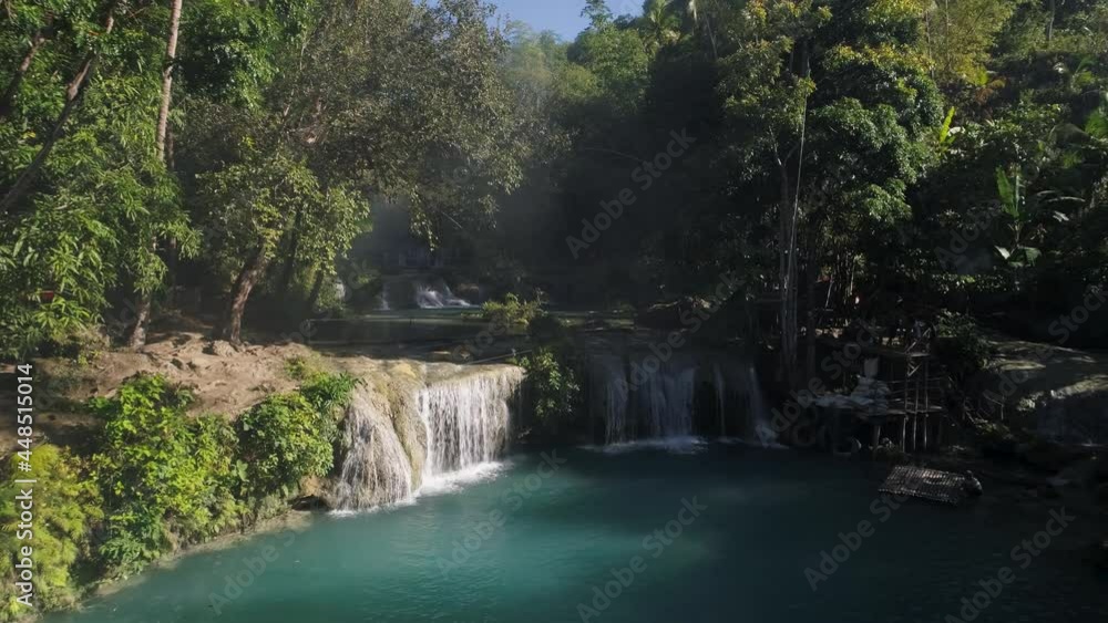 Cambugahay Falls swimming pool with kids using rope swing, tourist attraction, Siquijor Cambugahay Falls swimming pool with kids using rope swing, tourist attraction, Siquijor