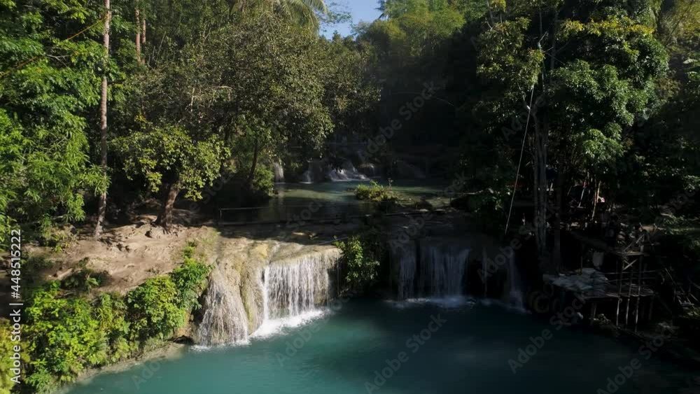 Tropical waterfall with blue pool at Cambugahay Fall on Siquijor island, no people Tropical waterfall with blue pool at Cambugahay Fall on Siquijor island, no people