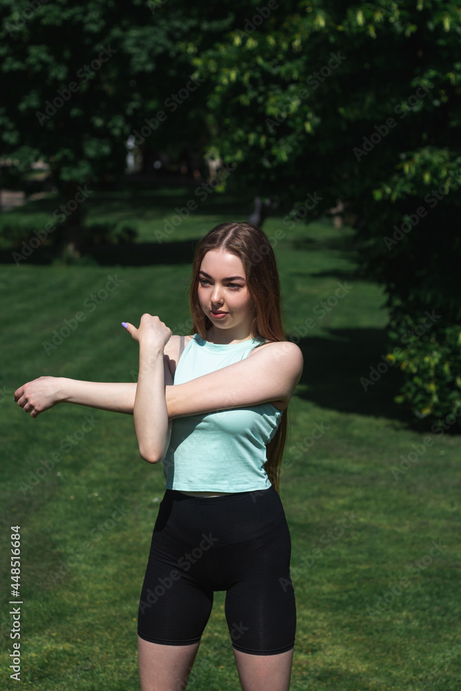 Young caucasian long-haired woman in sportswear is doing yoga in the park. Outdoor workout. Yoga poses Young caucasian long-haired woman in sportswear is doing yoga in the park. Outdoor workout. Yoga poses
