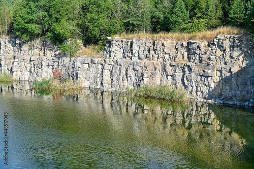 open pit filled with water and high cliffs