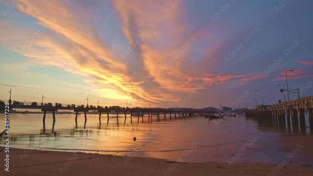 beauriful sunrise cloud above Chalong pier..Sunrise with sweet yellow color light rays and other atmospheric effects..colorful reflection of sunrise in the sea background. beauriful sunrise cloud above Chalong pier..Sunrise with sweet yellow color light rays and other atmospheric effects..colorful reflection of sunrise in the sea background.
