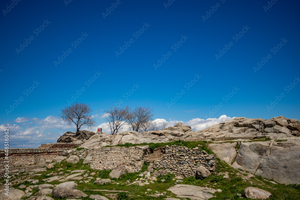 Vandalized monument with Swastika at Nebet Tepe, Plovdiv, Bulgaria. Blue sky hill view.