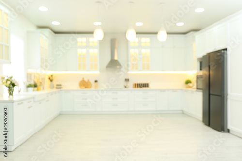 Blurred view of modern kitchen interior with stylish furniture