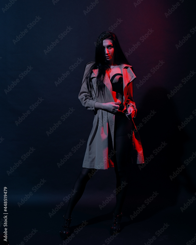 Woman in trench-coat and underwear in neon studio Woman in trench-coat and underwear in neon studio