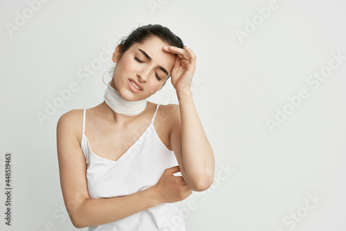 woman with head pain bandage around her neck health problems migraine