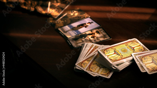 Blurred tarot cards on the table, esoteric concept, fortune telling predictions