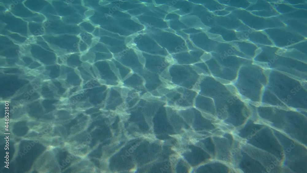 Hypnotic game of solar textures on a sandy bottom. Hypnotic game of solar textures on a sandy bottom.