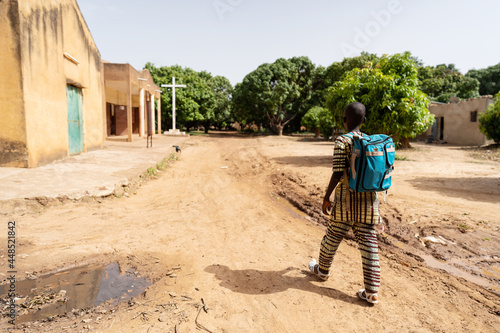 Photography Lonely well dressed black boy with blue backpack on the way to sunday school or