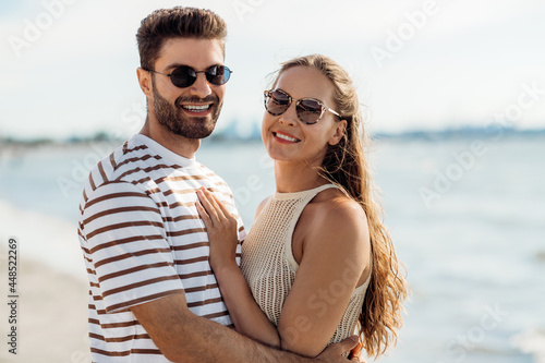 summer holidays and people concept - happy couple on beach