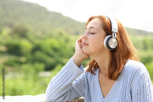 Woman resting listening to music in nature