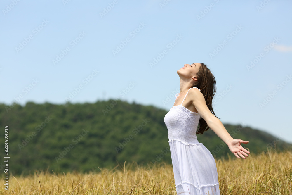 Woman breathing fresh air in a wheat field Woman breathing fresh air in a wheat field