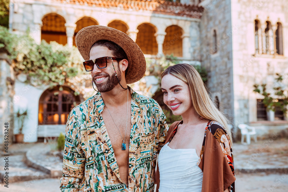 Stylish beautiful couple enjoying holidays in front of villa castle