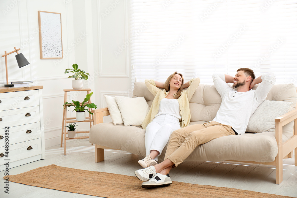 Couple relaxing on sofa in living room