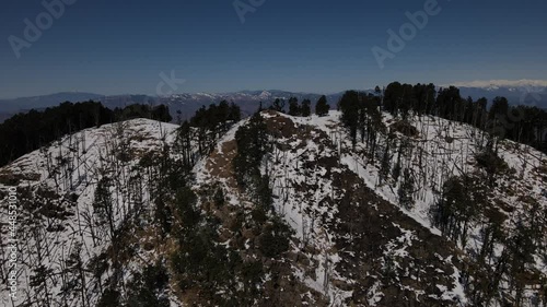 snow mountains covered with thick vegetation trees. aerial drone shot of Himalayan mountain range landscape. Nag Tibba mountain peak top photo