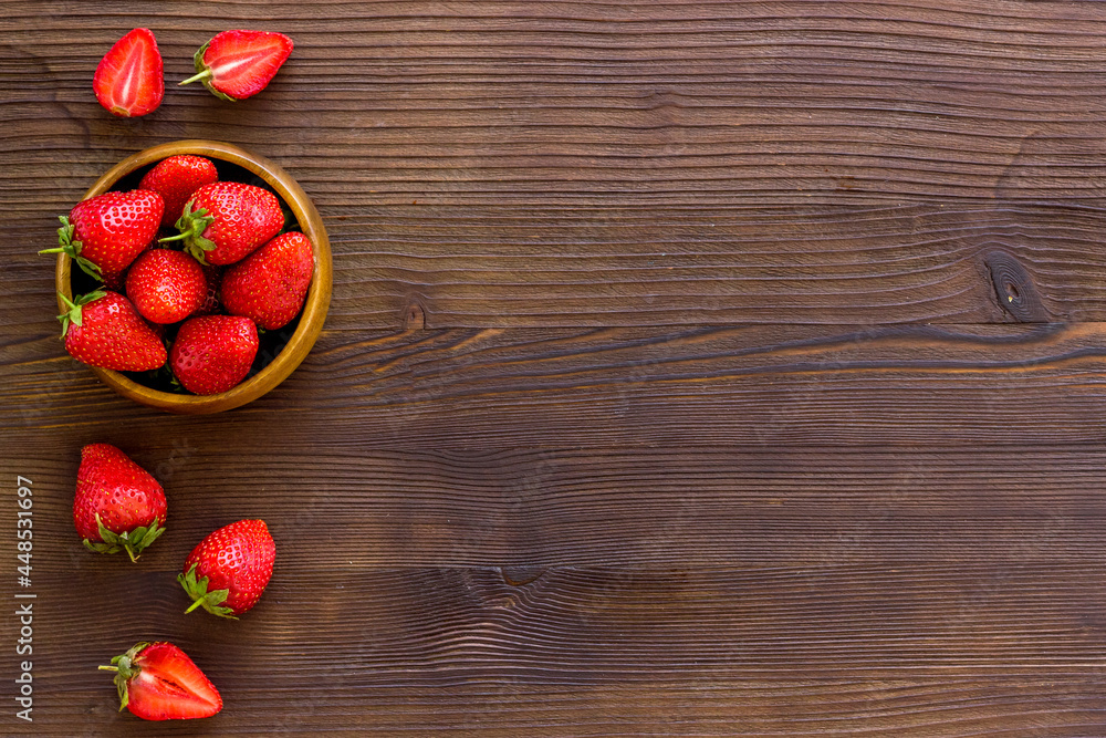 Juicy strawberry with leaves in bowl, top view Juicy strawberry with leaves in bowl, top view