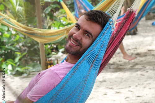 Guy enjoying a hammock in topical island 